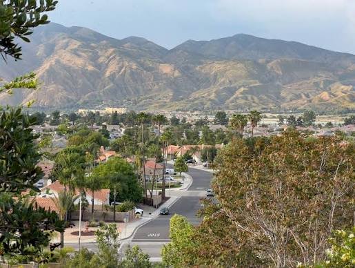A San Jacinto neighborhood spread across the valley floor with the rugged San Jacinto Mountains rising behind it