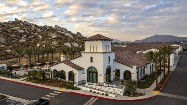 A Spanish-style community clubhouse in Moreno Valley set against the boulder-covered hills of Box Springs Mountain