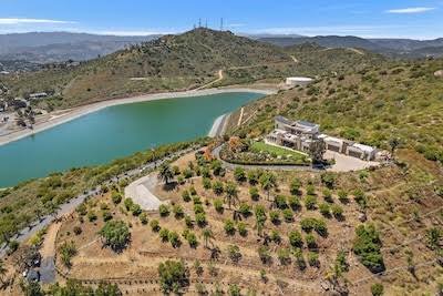 Aerial view of the Fallbrook hills with avocado groves and a reservoir