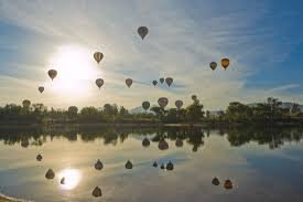 Hot-air balloons over the lake at sunrise in Temecula Wine Country