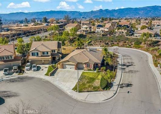 Aerial view of a Wildomar, California hillside neighborhood with mountain backdrop