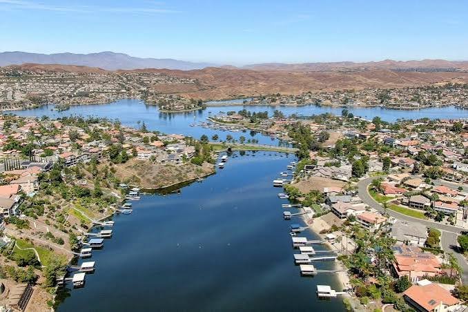 An aerial view of the Canyon Lake community with homes and private docks surrounding the blue reservoir