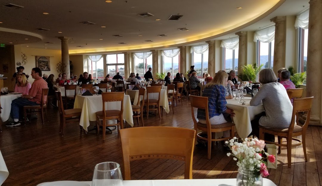 Diners enjoying a meal at a hilltop restaurant with valley views near Murrieta