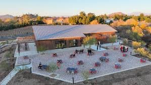 An aerial view of a hilltop winery patio near Murrieta at dusk