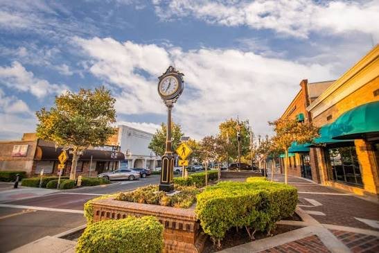 The vintage street clock and brick storefronts of Historic Downtown Lake Elsinore on Main Street