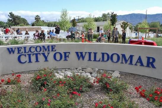 The Welcome to the City of Wildomar sign with the community gathered nearby