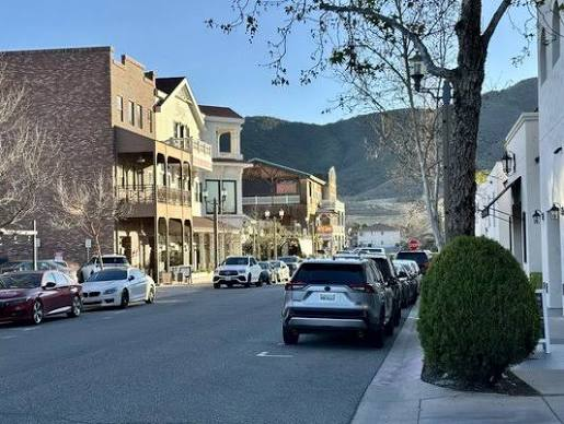 Historic downtown Fallbrook along Main Avenue, with brick storefronts and the hills rising in the distance