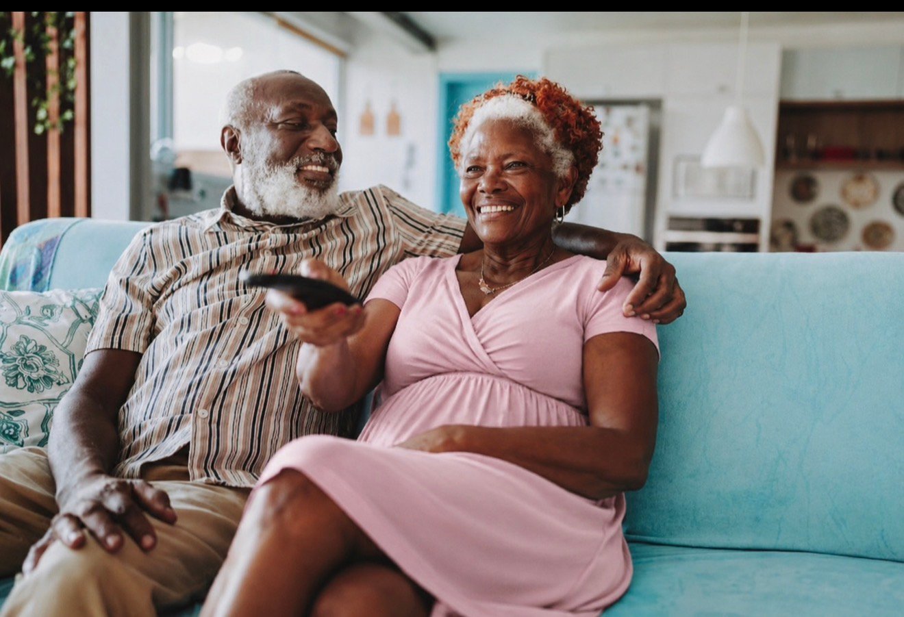 A senior couple relaxing comfortably together at home in Riverside