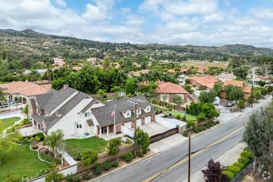 Aerial view of Hemet homes and tree-lined streets with the San Jacinto foothills beyond