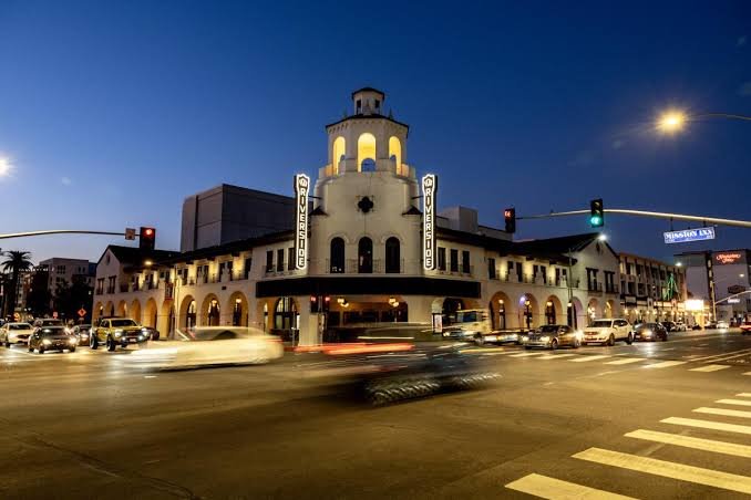 The historic Riverside fox theater building lit up at dusk in downtown Riverside