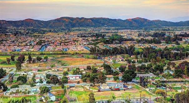 Aerial view of Wildomar, California neighborhoods with mountains in the background