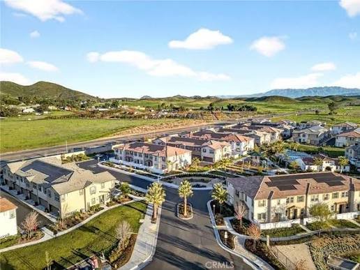 Aerial view of a new Winchester, California residential community with mountains in the background